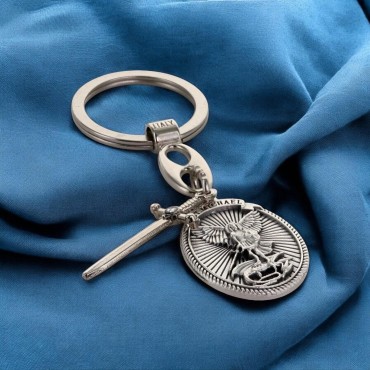 Porte-clés ovale en métal avec Saint Michel entouré de rayons, breloque épée H. 3 cm.