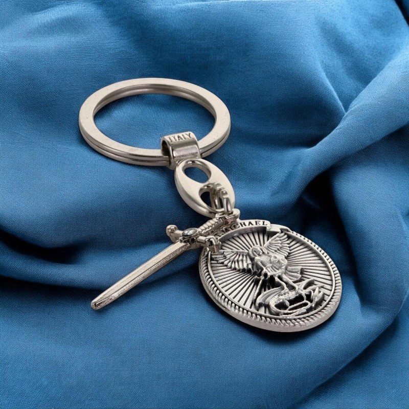 Porte-clés ovale en métal avec Saint Michel entouré de rayons, breloque épée H. 3 cm.
