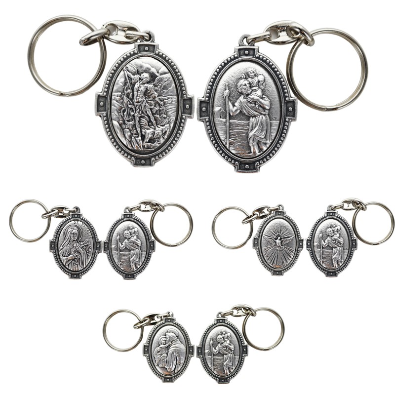 Porte-clés H. 4.5 cm en métal couleur argentée forme ovale double face, plusieurs saints.