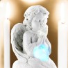 Ange assis en pière avec un coeur lumière tournante- Hauteur 9 cm