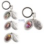 Porte-clés médaille de saint Benoît en métal couleur argentée ouvrant H. 4,5 cm double résine, plusieurs saints.