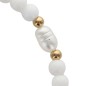 Bracelet sur elastique avec grains ovales en acrylique et grains ronds, agremente d une croix en metal doree. LOT DE 2